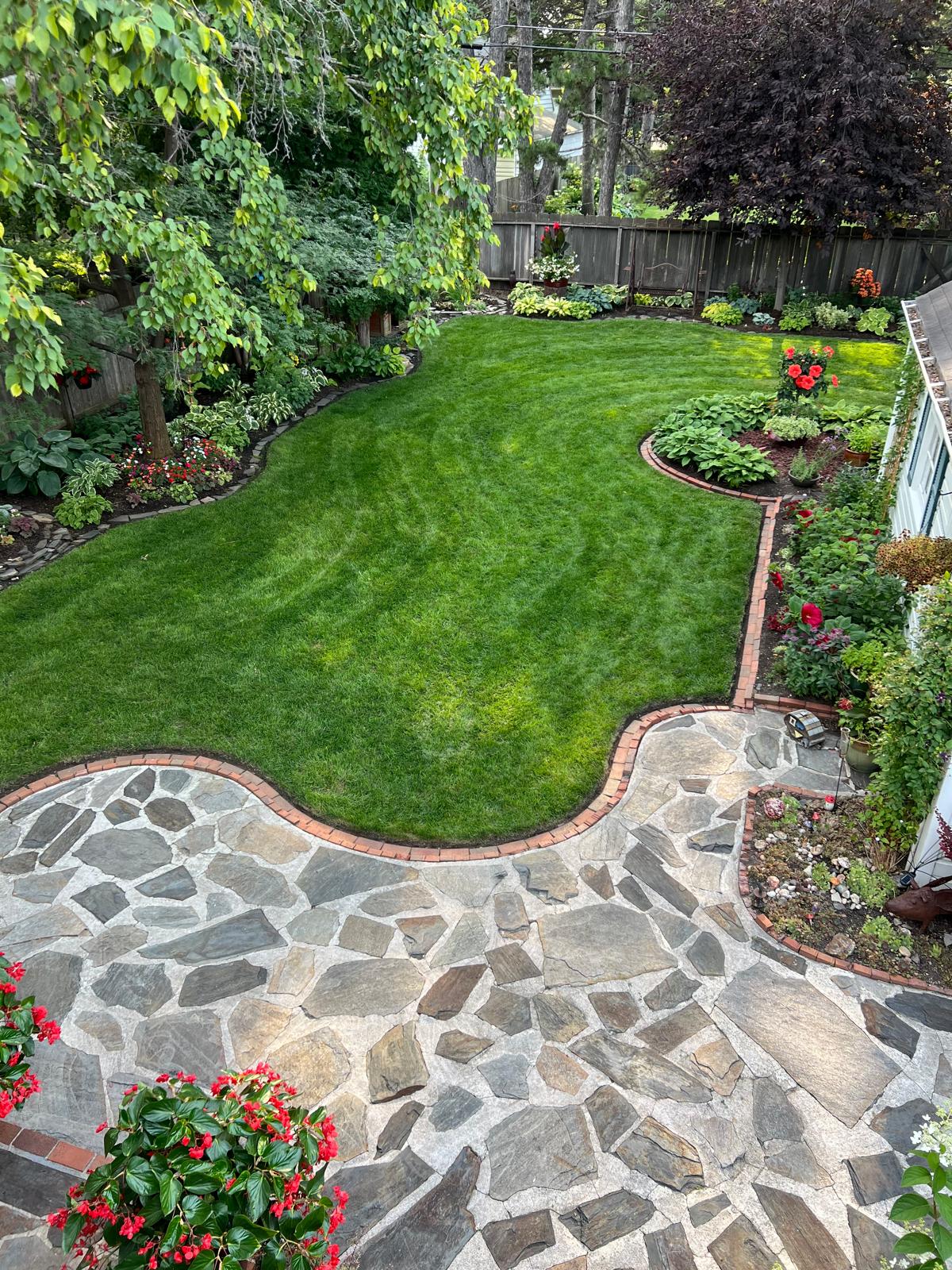 A beautifully landscaped garden with various plants, trees, and flowers